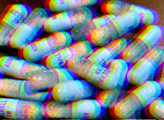 Orange Adderall capsules with blue lids, scattered in a pile with a psychedelic art effect.